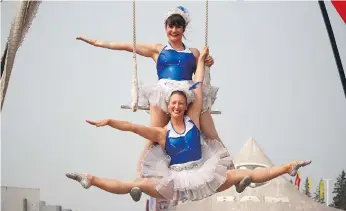  ?? ALEXA LAWLOR ?? The Silver Starlets, Glory Dearling, top, and Molly Keczan, pose on the duo trapeze at the Saskatoon Ex on Thursday. The Silver Starlets perform daily at the Saskatoon Ex at 3:30 p.m., 5 p.m., and 7:30 p.m.