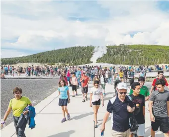  ?? Provided by Jacob W. Frank, National Park Service ?? Crowds leave after an Old Faithful eruption at Yellowston­e National Park in July 2017.