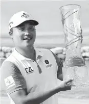  ?? EMIL LIPPE AP ?? K.H. Lee of South Korea holds up the AT&T Byron Nelson trophy after winning on Sunday. Lee shot a 9-under 63 to finish a stroke ahead of Jordan Spieth.