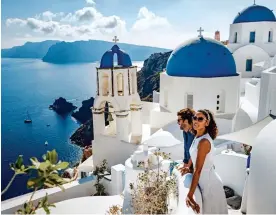  ??  ?? SUN-DRENCHED: The stunning white-and-blue buildings of Santorini
