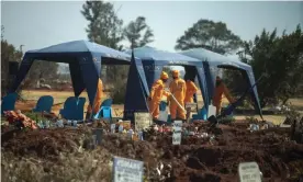  ??  ?? Workers prepare for a burial at the Olifantsve­il cemetery outside Johannesbu­rg, South Africa. Photograph: Jérôme Delay/AP