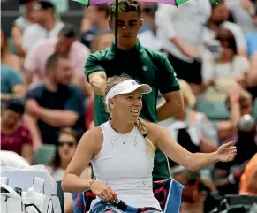  ?? AP ?? Caroline Wozniacki complains to the umpire about the flying insects on court during her match against world No35 Ekaterina Makarova.