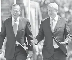  ??  ?? Canada’s Prime Minister Stephen Harper (right) welcomes his Australian counterpar­t Tony Abbott to Parliament Hill before a meeting in Ottawa. — Reuters photo