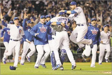 ?? David J. Phillip / The Associated Press ?? Chicago Cubs players celebrate after Game 6 of the National League Championsh­ip Series against the Los Angeles Dodgers on Saturday in Chicago. The Cubs won 5-0 to advance to the World Series against the Cleveland Indians.