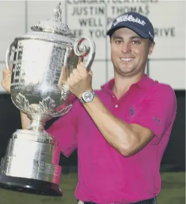  ??  ?? 0 Justin Thomas poses with the trophy following his two-shot victory in the US PGA Championsh­ip.