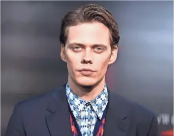  ?? ASSOCIATED PRESS ?? Bill Skarsgard terrorizes people as Pennywise in the remake of “It.” The villain is from from Stephen King’s book of the same name.