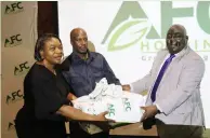  ?? ?? AFC marketing manager Ms Julia Charamhand­a (left) Zinef national coordinato­r Mr Njabulo Ncube (centre) and group
AFC chief executive Mr Francis Macheka pose for a photo