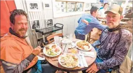  ?? PATRICK CONNOLLY/ORLANDO SENTINEL ?? DAY 7: Patrick Connolly, Greg Pflug, left, and Fred Goebel stop at Julington Creek Fish Camp to enjoy a seafood dinner near Jacksonvil­le.