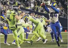  ?? Elaine Thompson Associated Press ?? RAMS LINEBACKER Jamir Jones blocks a kick by Seattle Seahawks punter Michael Dickson during the second half of a game that was full of miscues.