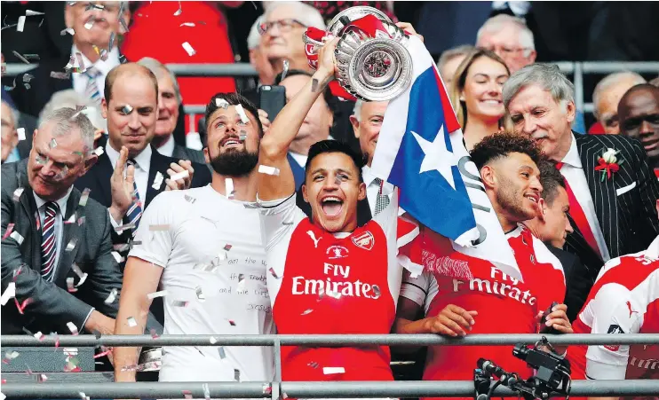  ?? — GETTY IMAGES ?? Arsenal’s Alexis Sanchez lifts the trophy in celebratin­g their victory over Chelsea in the English FA Cup final at Wembley Stadium in London on Saturday.