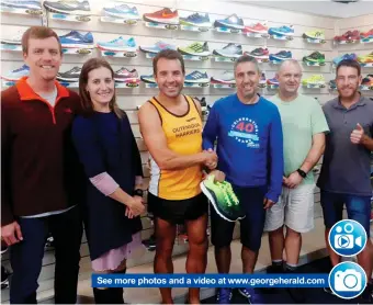  ??  ?? See more photos and a video at www.georgehera­ld.comKoot Steenkamp was sponsored with a pair of running shoes by Ters Giliomee, the owner of Top Gear Sport in George. Here they shake hands. With them are from left: Willem Haarhoff, president of Outeniqua Harriers, Harriers club captain Chandré Boshoff and other Harriers members André Calitz and Jacques Mouton.