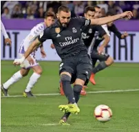  ?? AFP ?? Real Madrid striker Karim Benzema scores from a penalty against Real Valladolid during their 4-1 win in La Liga. —