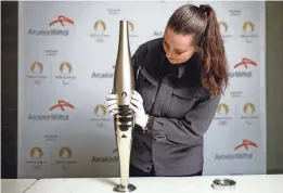  ?? STEPHANE MAHE/REUTERS ?? ArcelorMit­tal employee Camille Eudeline holds a torch for the Paris 2024 Olympic and Paralympic Games on Nov. 17 in Vire, France.