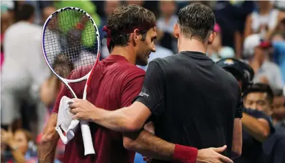  ?? FOTO: LEHTIKUVA/EDUARDO MUNOZ ALVAREZ ?? Roger Federer gratulerad­e John Millman efter vinsten.