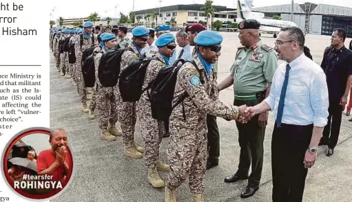  ?? PIC BY MUHAMMAD SULAIMAN ?? Defence Minister Datuk Seri Hishammudd­in Hussein (right) and Armed Forces chief General Tan Sri Raja Mohamed Affandi Raja Mohamed Noor (second from right) sending off the first batch of Malbatt 850-5 at the Subang airbase yesterday.