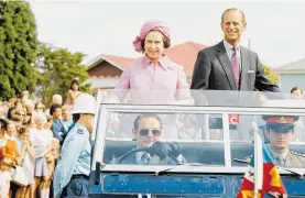  ?? Photos / Getty Images, File ?? The royals during their visit in 1977, and below: “When are you going to release your hair?” asked Philip when he saw Lynne White, with curlers.