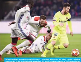  ?? — AFP ?? DECINES-CHARPIEU : Barcelona’s Argentinia­n forward Lionel Messi (R) plays the ball during the UEFA Champions League round of 16 first leg football match between Lyon (OL) and FC Barcelona on Tuesday, at the Groupama Stadium in Decines-Charpieu, central-eastern France.