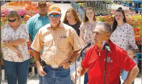  ?? Westside Eagle Observer/RANDY MOLL ?? Johnny Gunsaulis, U of A Extension agent for Benton County, spoke to those gathered to honor the Jim and Michele Pigeon Family on Friday.