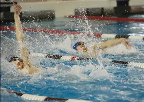  ?? Photo by Louriann Mardo-Zayat
/ lmzartwork­s.com ?? Cumberland senior Ian Horstkamp-Vinekar, right, competes against Lincoln’s McGovern Brown during the 100-yard backstroke that took place Saturday as part of the R.I. Interschol­astic League Boys Swimming State Championsh­ips that were held at Brown University. Horstkamp-Vinekar claimed the event and also took first place in the 100-yard butterfly.