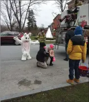  ?? MELISSA SCHUMAN - MEDIANEWS GROUP ?? The Easter Bunny poses for a photo with a child.
