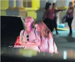  ?? MATT MCCLAIN/THE WASHINGTON POST ?? Reunited relatives leave the Coral Springs Marriott at Heron Bay on Feb. 14 after the mass shooting at Marjory Stoneman Douglas High School. As the crowd thinned, those who still had no word on their children waited in agony for hours.