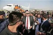  ?? [AP PHOTO] ?? Afghan first vice president, a former Uzbek warlord, Gen. Abdul Rashid Dostum, center, and members of his entourage arrive Sunday at Kabul Internatio­nal Airport in Kabul, Afghanista­n, shortly after a large explosion killed at least 14 people.