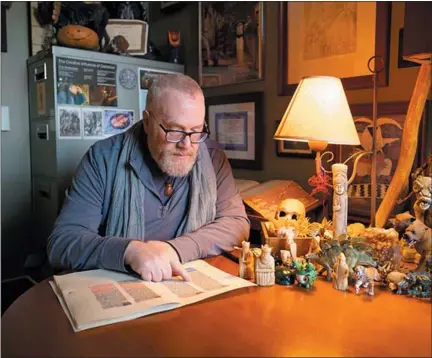  ?? CMU PHOTOS ?? Ari Berk, professor of folklore and mythology at Central Michigan University, is pictured with a variety of mythical figurines.