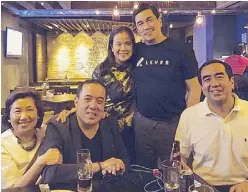  ?? PHOTO COURTESY OF MARTIN D. BAUTISTA/ ?? Calm before the storm. Susan Bautista-Afan (left), with the Comelec chairman (right) and another brother, Martin (standing), enjoying themselves in a Makati bar in February 2017. Martin has said that the San Francisco condominiu­m that is not listed in...
