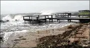  ?? AJC FILE ?? Waves crash over the rocks near the Cedar Street beach access at St. Simons Island. The Georgia Department of Natural Resources said numerous loggerhead turtle nests were washed away by recent flooding.