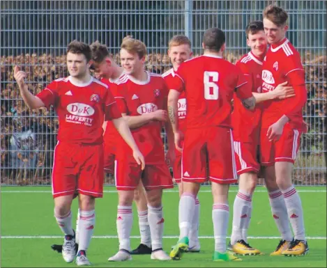  ?? Match report and photos: Derek Black. ?? Cammy Hill is congratula­ted by his teammates after netting the first of his two goals against Rutherglen on Saturday.