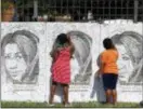  ?? CARLOS OSORIO — THE ASSOCIATED PRESS ?? Kids sign poster boards with the image of Aretha Franklin at the Charles H. Wright Museum of African American History during a public visitation for Franklin, Wednesday in Detroit. Franklin died Aug. 16, of pancreatic cancer at the age of 76.