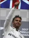  ?? OLIVIER MATTHYS, THE ASSOCIATED PRESS ?? Winner Lewis Hamilton gives a thumbs-up on the podium Sunday.