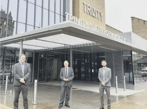  ??  ?? HANDOVER: CEO of Trinity Multi-Academy Trust Michael Gosling, left, Calderdale Council leader Tim Swift and Councillor Adam Wilkinson