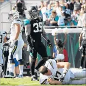  ?? Logan Bowles Getty Images ?? CHARGERS quarterbac­k Philip Rivers lies on the ground as Jacksonvil­le’s Tashaun Gipson looks on.