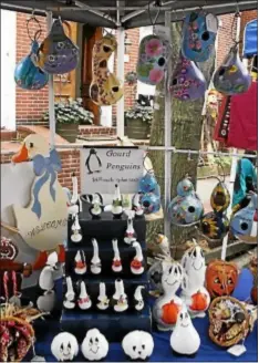 ??  ?? At last year’s festival, visitors had a large selection of various crafts, like these Gourd penguins and Halloween ghosts, to purchase.