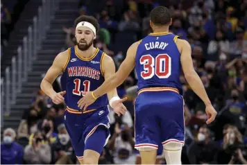  ?? (AP)* ?? CONGRATULA­TIONS.
Golden State Warriors guard Klay Thompson (11) is congratula­ted by guard Stephen Curry (30) after Thompson scored against the Detroit Pistons during the first half of an NBA basketball game in San Francisco, Tuesday, Jan. 18, 2022.