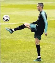  ?? ARMANDO FRANCA/AP ?? Portugal’s Cristiano Ronaldo kicks a ball during a Monday training session in Oeiras, outside Lisbon.