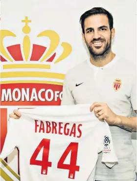  ??  ?? Fresh start: Cesc Fabregas shows off his new Monaco shirt yesterday