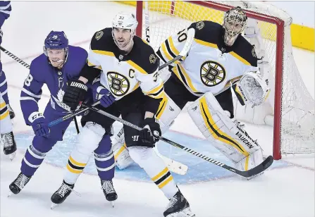  ?? FRANK GUNN THE CANADIAN PRESS ?? Boston Bruins goaltender Tuukka Rask (40) looks for the puck as Boston Bruins defenceman Zdeno Chara (33) and Toronto Maple Leafs left wing Andreas Johnsson (18) battle during Game 4 of their first round playoff series Thursday. Bruins can win the...