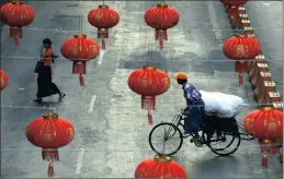  ?? PICTURE: EPA ?? A trishaw drives along a road decorated with Chinese lanterns in Yangon, Myanmar.
