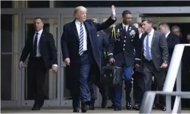  ?? Photograph: Getty Images ?? Donald Trump leaving the CIA headquarte­rs in January 2017 in Langley, Virginia. In the background a military aid carries the ‘football’, with launch codes for nuclear weapons.