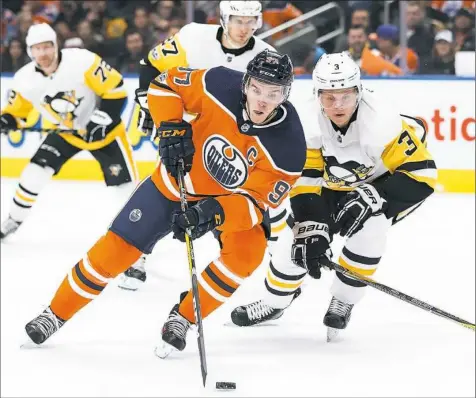  ?? Codie McLachlan/Getty Images ?? A healthy and confident Olli Maatta zeroes in on Oilers star Connor McDavid Wednesday night in Edmonton, Alberta.