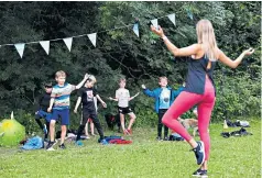  ??  ?? Bianca Kellaway leads an outdoor yoga class