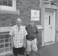  ?? Joseph B. Nadeau/The Call ?? Glenn Dusablon, left, and Roger Beaudry stand outside of the American-French Genealogic­al Society building at 78 Earle St.