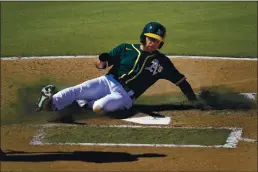  ?? MATT YORK — THE ASSOCIATED PRESS ?? The A’s Jed Lowrie scores on a single by Stephen Piscotty during the fourth inning of Wednesday’s Cactus League game against the Kansas City Royals in Mesa, Ariz.