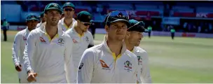  ?? AFP ?? Australian skipper Smith leads his players off the field after losing the Test against South Africa. —