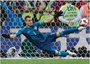  ?? Juan Mabromata / AFP/Getty Images ?? Russia’s keeper Igor Akinfeev spreads out to get a foot on Spain’s final attempt in the shootout.