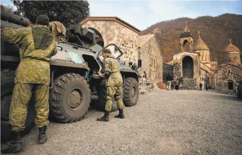  ?? Alexander Nemenov / AFP / Getty Images ?? Russian peacekeepi­ng troops gather at Dadivank, an Armenian Apostolic Church monastery near the town of Kelbajar, Azerbaijan.