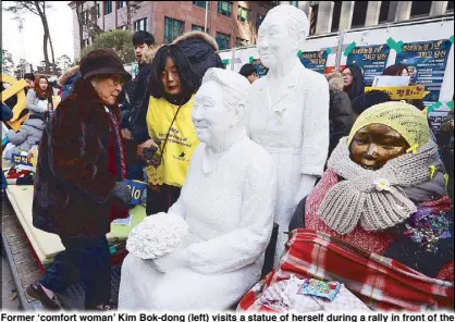  ?? EPA ?? Former ‘comfort woman’ Kim Bok-dong (left) visits a statue of herself during a rally in front of the Japanese embassy in Seoul on Monday.