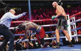  ?? CHASE STEVENS/ASSOCIATED PRESS ?? England’s Tyson Fury knocks out Deontay Wilder to win in the 11th round in a heavyweigh­t championsh­ip match Saturday in Las Vegas.
